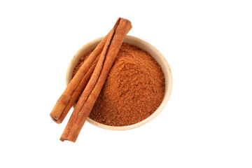 Cinnamon powder and sticks on white
