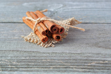 Cinnamon sticks on wooden background
