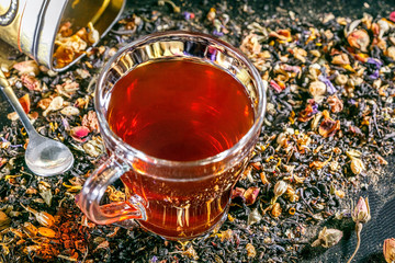 Glass cup with flower tea. Red herbal tea.