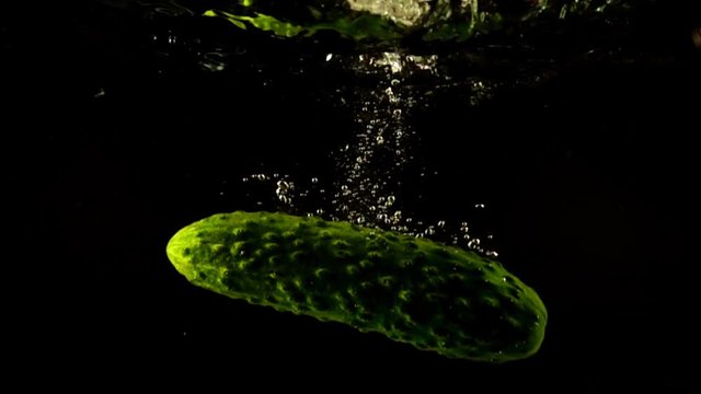 Falling of cucumber in water. Slow motion.