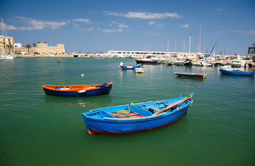 Fototapeta na wymiar Colorful fishing boats in harbour of Bari city, Puglia, Southern Italy