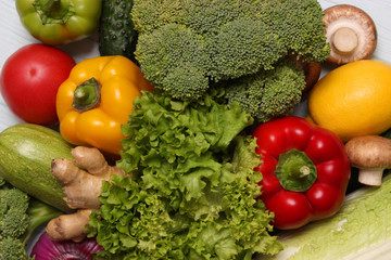 set of different fresh vegetables on wooden background top view closeup. Diet, healthy food, veggie.