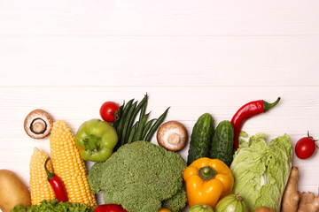 Different fresh vegetables on a wooden table top view. Proper and healthy food, diet, vegetarian. Cooking food, vegetable dishes. flat lay