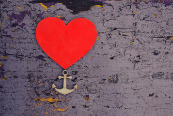 wooden heart and anchor on the rustic painted wooden board