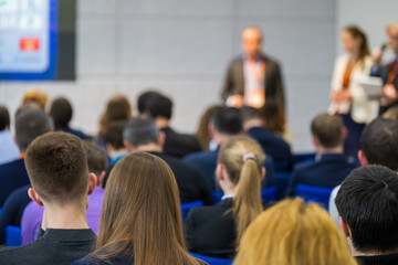 People attend business conference in the congress hall