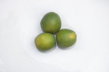 Three oranges on a white background