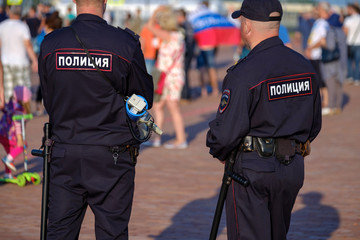 Policemans on the city street, back view