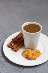 Cup of coffee with sweet mini cookies  on grey concrete background. Free space for text.
