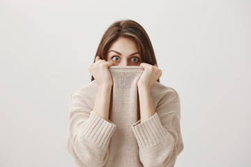 Woman hears terrifying story making her tremble from fear. Portrait of cute adult caucasian girl...