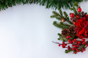 Christmas frame decorations. Mistletoe, holly, garlands and green tinsel. White background . Top View. Copy Space