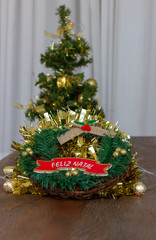 Garlands with Merry Christmas written in Portuguese. Feliz natal . Christmas tree on background. Copy Space