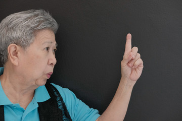 old asian elderly elder senior woman pointing up