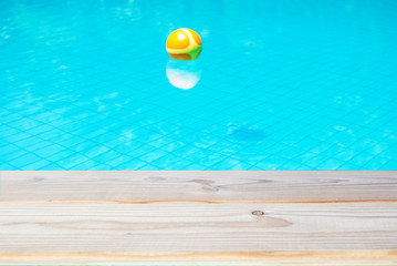 empty table on the swimming pool background