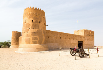Al Zubara Fort (Az Zubarah Fort), historic Qatari military fortress built from coral rock and limestone and cemented with a mud mortar, old cannon nearby, UNESCO world heritage listed