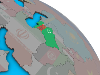 Turkmenistan with embedded national flag on simple blue political 3D globe.