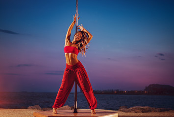 Young woman pole dancing