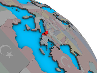Albania with embedded national flag on simple blue political 3D globe.