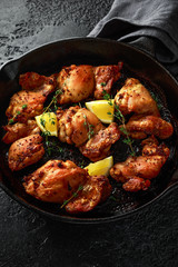 Roasted boneless skinless chicken thighs in lemon and thyme dressing served in vintage cast iron...