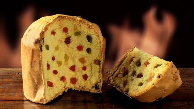 panettone, decorative christmas food, on wooden table, fire background