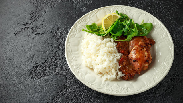 Roasted boneless skinless chicken thighs with rice and green vegetables mix