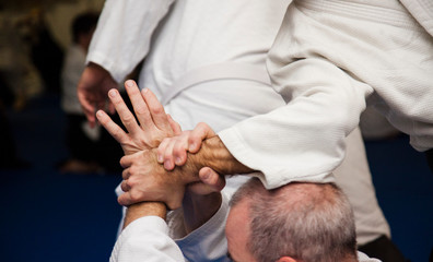 Aikido athletes train in the dojo. Aikidoki work out the elements of aikido equipment
