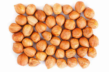 Heap of hazelnuts isolated on white background, macro image