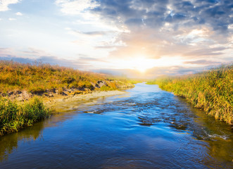 blue rushing river at the sunset
