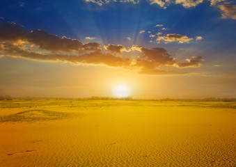 dramatic sunset over a hot sandy desert