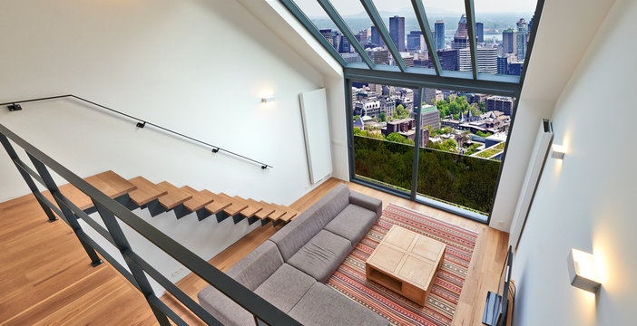 Modern Living Room With Large Windows And View On City Panorama.