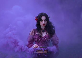Pandora's box The treacherous brunette girl in a luxurious dress is holding an open casket in her...
