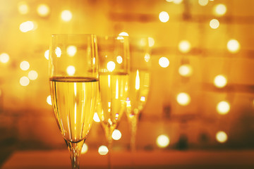champagne glasses on bokeh lights background