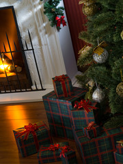 view of wrapped gifts and fireplace with christmas tree on the back