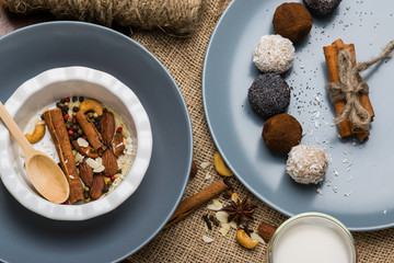 A plate with nuts, cinnamon. Blue dishes on burlap.