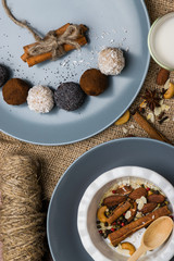 A plate with nuts, cinnamon. Blue dishes on burlap.
