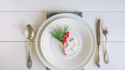 Christmas table setting with traditional Christmas decoration in white red tone. Beautiful festive...