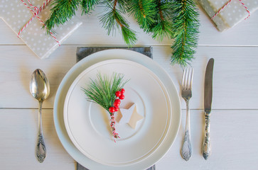 Christmas table setting with traditional Christmas decoration in white red tone. Beautiful festive...