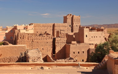 Traditional Moroccan palace called kasbah in local language, a bit ruined, made of clay called pise, beautifully decorated, view from outsidee