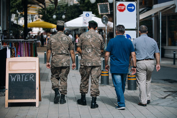 Two soldiers is walking at the street of Nicosia