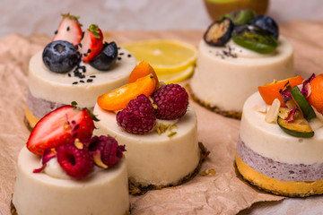 Bright cupcake with fruit and berries on a light background.