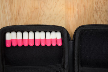 Pink and white capsule