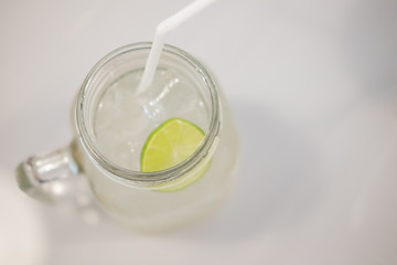Fototapeta na wymiar Glass of Mojito cocktail or soda drink with lime