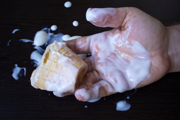 ice cream smeared on the hand, the concept of obesity, a lot of sweet, the harm of sweet