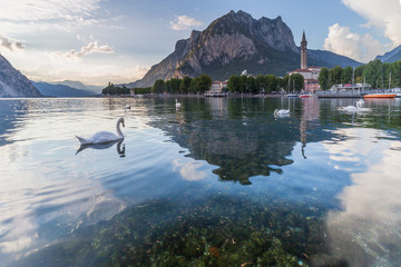 Lecco, lake Como, Lombardy, Italy. View of the city with the St. Martin mount reflected in the lake's waters - obrazy, fototapety, plakaty