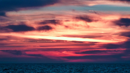 Fototapeta na wymiar Aviation trail sunset at the beach