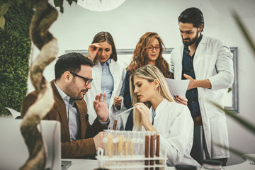 Scientist Examining Samples With Plants