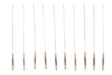 Silver needle acupuncture on an isolated white background. Close-up.