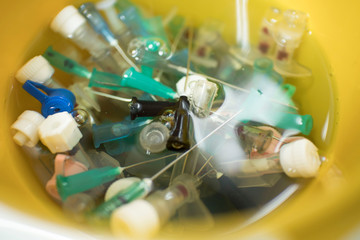 needles and syringes in disinfectant. disposal of medical needles and syringes and medical waste