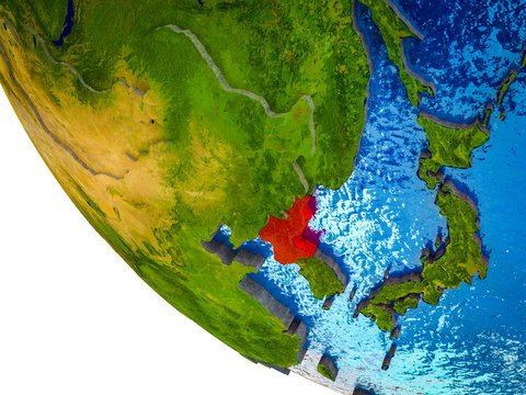 North Korea on model of Earth with country borders and blue oceans with waves.