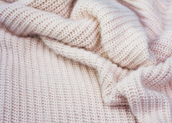 Knitted white folded mellow wool, winter seasonal background.