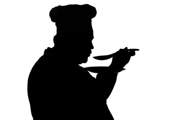 silhouette of a chief-cooker tasting dish on a white isolated background, profile of a male face in...